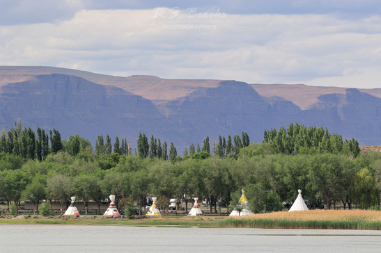 teepees along the shore by a cliff photo by KS Brooks