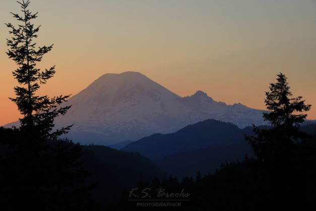 Mount Rainier with the sun setting behind it flash fiction writing prompt