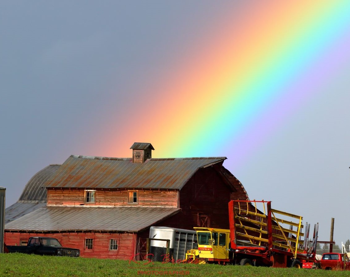 end of a rainbow at a red barn copyright KS Brooks