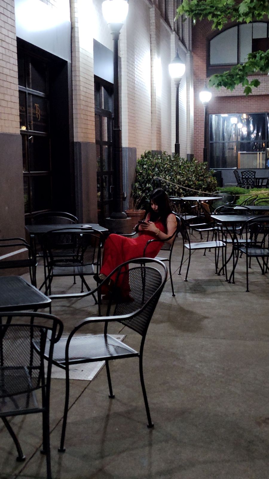 woman in a formal dress alone looking at her phone flash fiction writing prompt