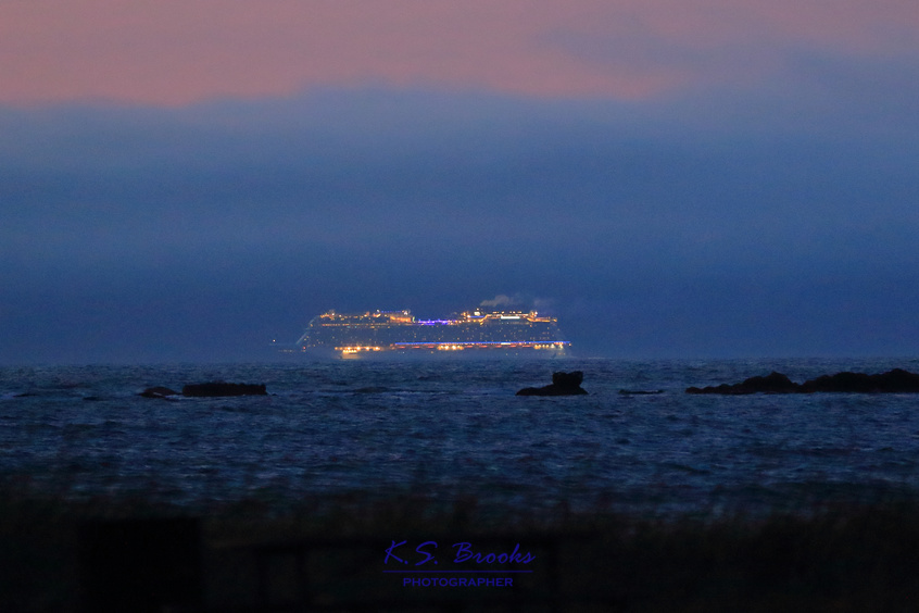 cruise ship at dusk with lights glowing copyright KS Brooks