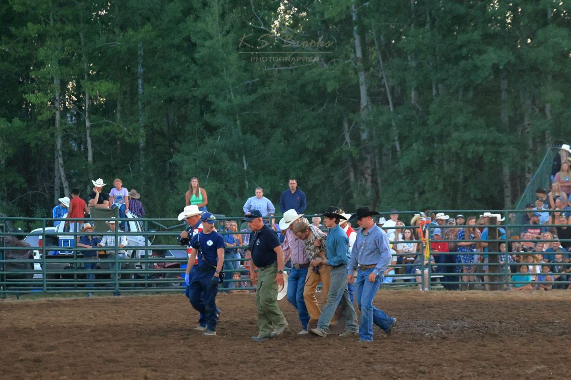 cowboy walking out of the arena after falling off a bronco by K.S. Brooks