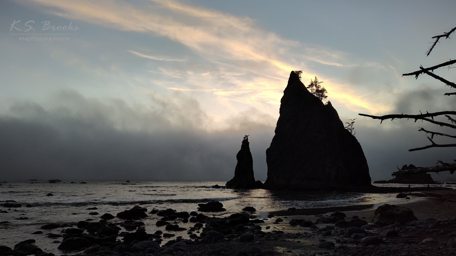creepy sea stacks at dusk with marine layer rolling in